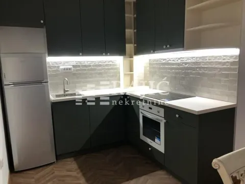 Modern kitchen with dark cabinets and a white countertop. - image 3