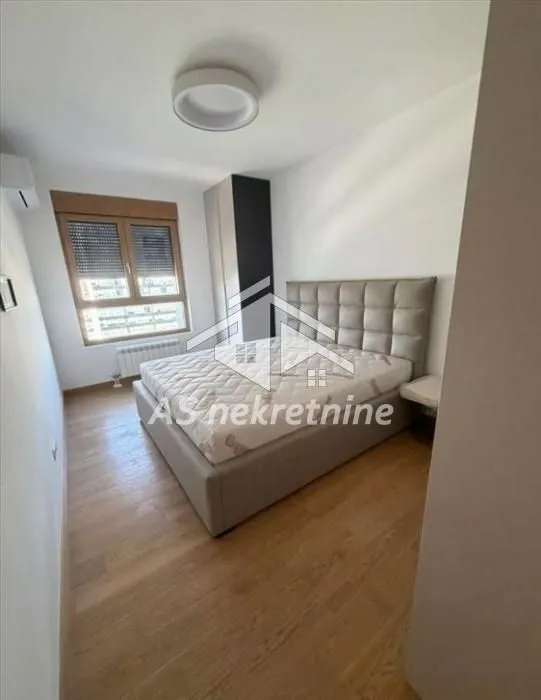 Bedroom with a double bed, wardrobe, and window.
