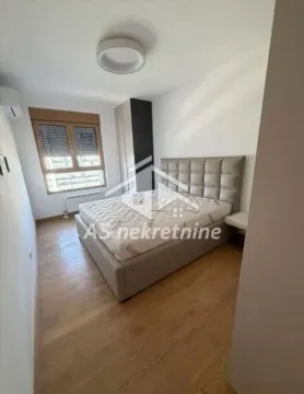 Bedroom with a double bed, wardrobe, and window. - image 10