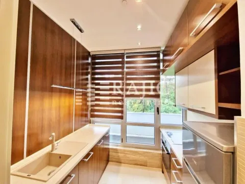 Modern and tidy kitchen with wooden elements. - image 2