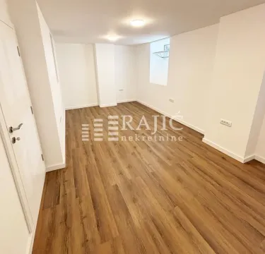 Empty room with laminate flooring and white walls. - image 4