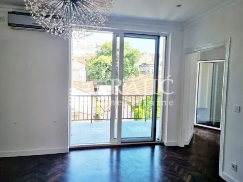 Living room with hardwood floors, modern chandelier, and access to the terrace. - image 12