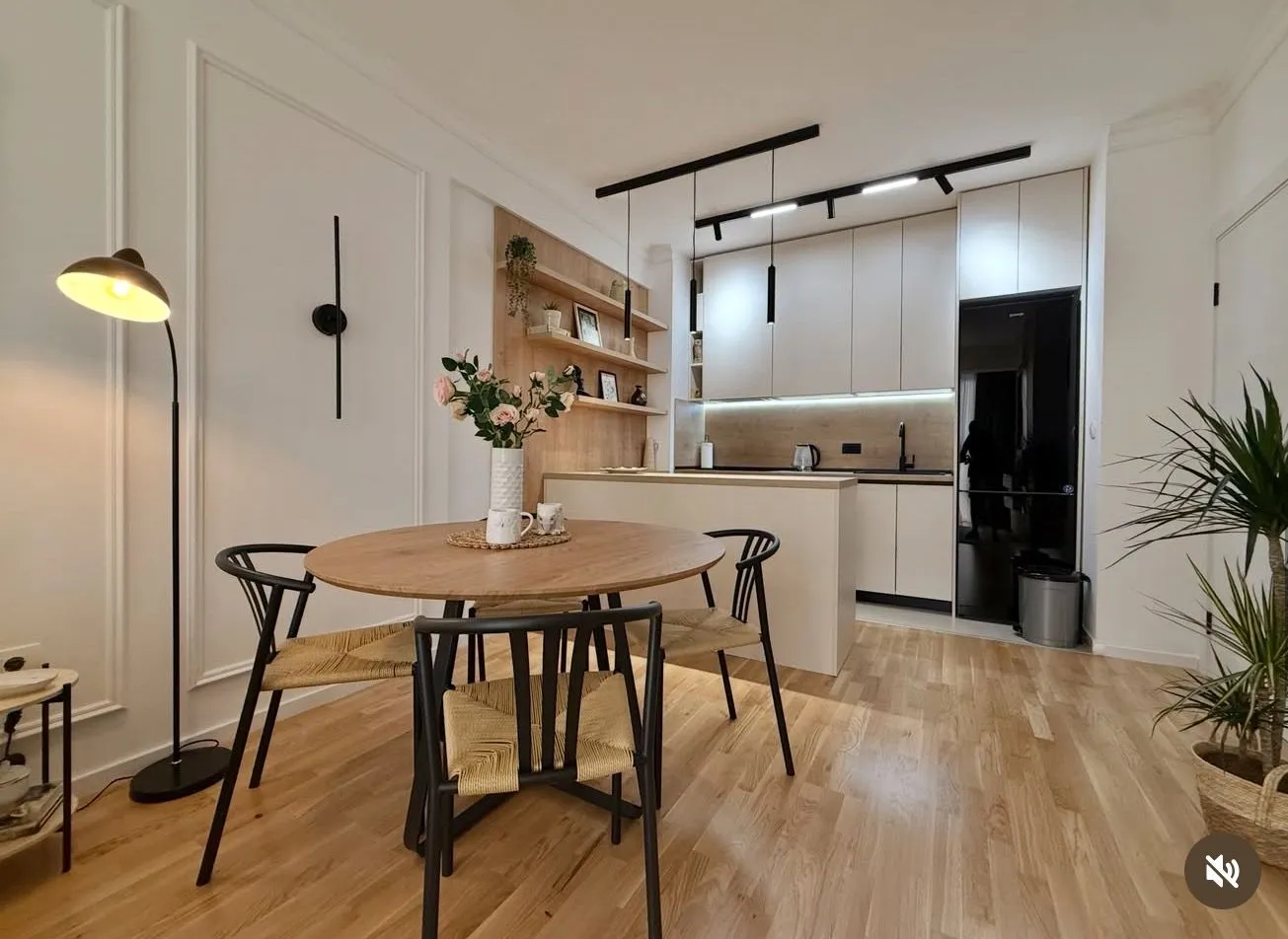 Modern kitchen with dining area and built-in appliances.