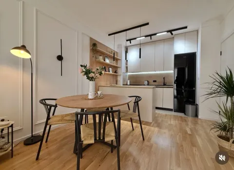 Modern kitchen with dining area and built-in appliances. - image 4