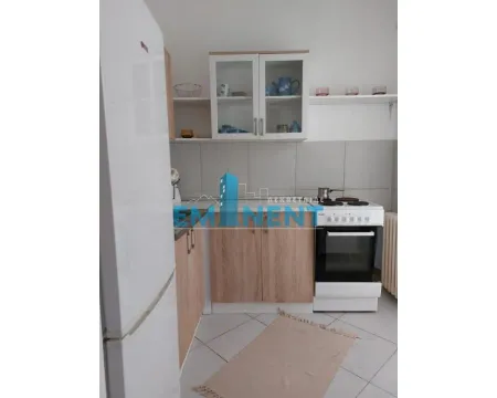 Small kitchen with a white refrigerator, wooden cabinets, and a stove. - image 6