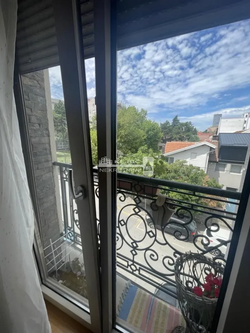 View from the balcony overlooking the urban surroundings and street.