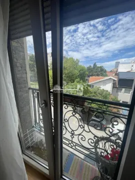View from the balcony overlooking the urban surroundings and street. - image 11