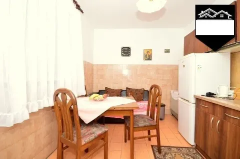 Smaller kitchen with a dining table and chairs. - image 7