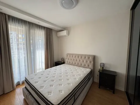 Bright bedroom with a double bed and nightstands. - image 6