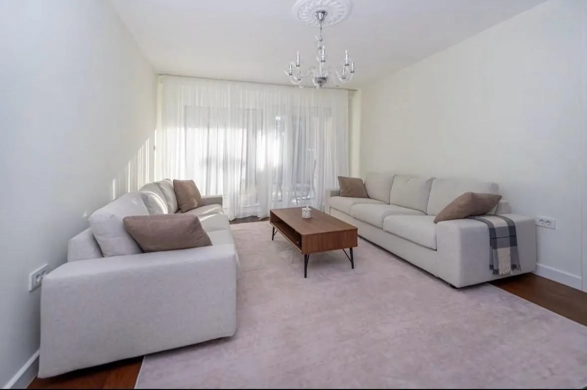 Spacious living room with a sofa set and a coffee table.