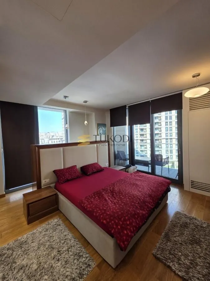 Spacious bedroom with a large double bed and access to the terrace.