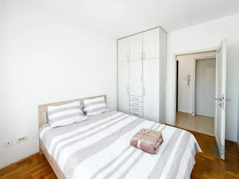 Bedroom with a double bed, white wardrobe, and wooden floor. - image 5