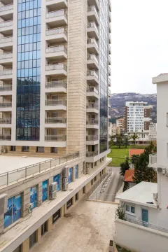 View of the exterior of a modern residential building and surroundings. - image 8