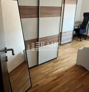 Furnished bedroom with a large wardrobe and a desk. - image 7