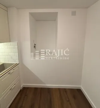 Part of the kitchen with white cabinets and a white wall. - image 15