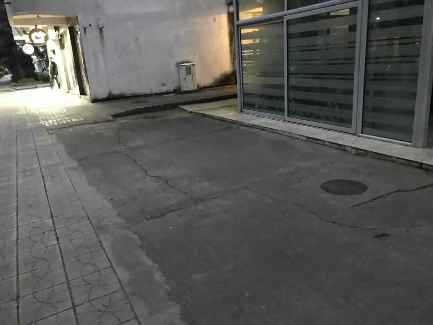 Exterior of the commercial space with an entrance and concrete surface.