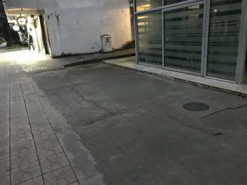Exterior of the commercial space with an entrance and concrete surface. - image 3