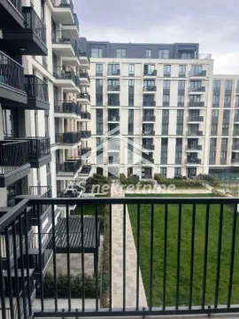 View from the balcony overlooking the courtyard and the residential building facade. - image 11