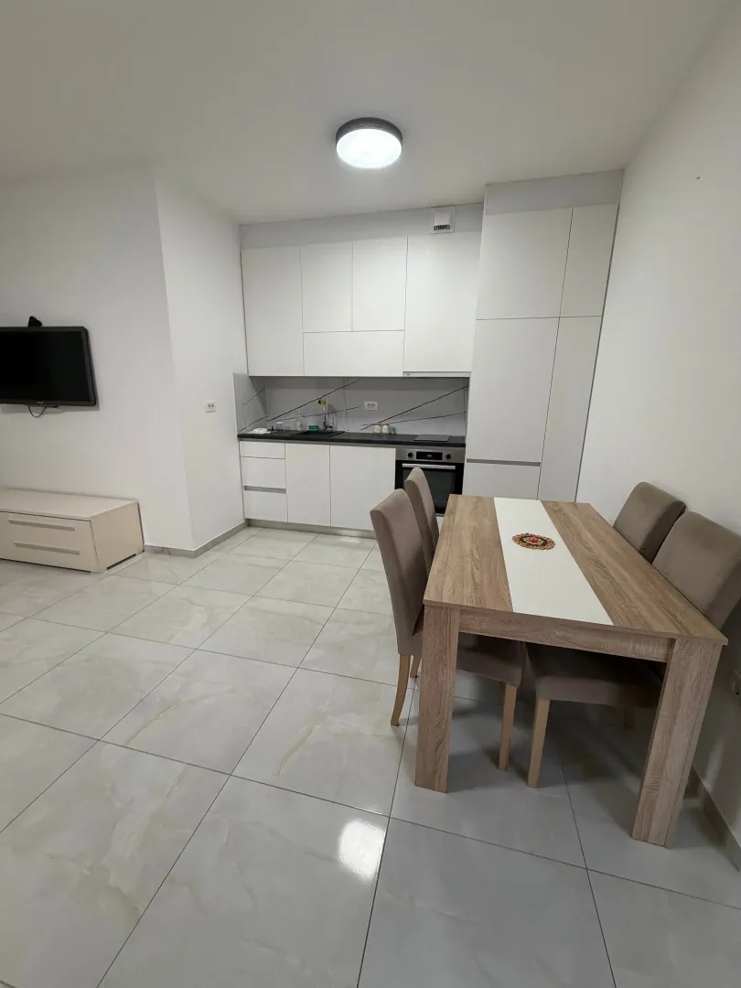 Modern kitchen with a dining area and white cabinets.