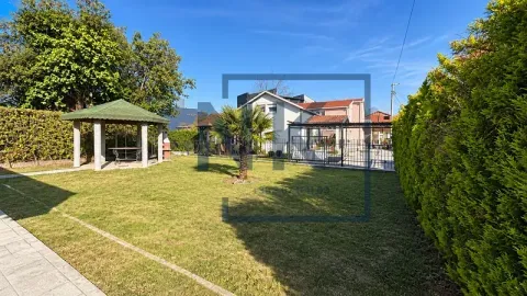 Yard with a landscaped lawn, gazebo and a view of the house. - image 4