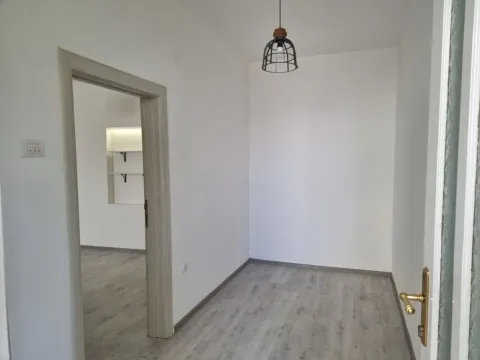 Empty bright room with light wooden flooring and a pendant light. - image 3