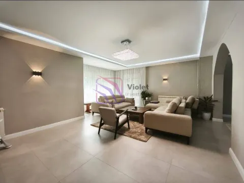 Spacious living room with a seating set and modern lighting. - image 3