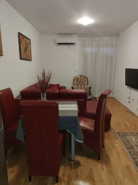 Living room with a red leather sofa set and a dining table. - image 10