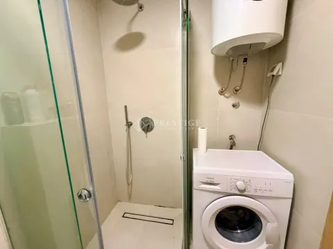 Smaller bathroom with a shower cabin and a washing machine. - image 10