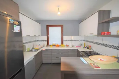 Bright kitchen with grey and white cabinets. - image 3