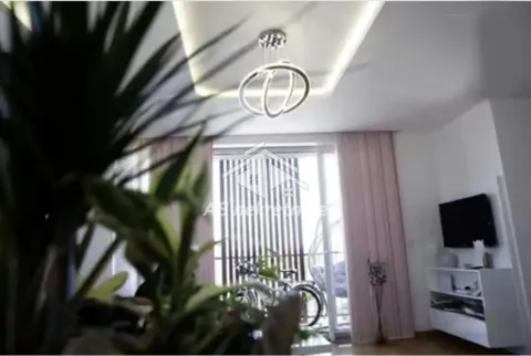 Living room with a modern chandelier and access to the terrace. - image 2