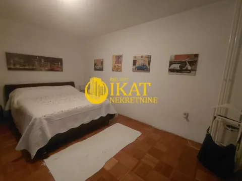 Furnished bedroom with a double bed, parquet flooring, and decorative pictures on the wall. - image 5