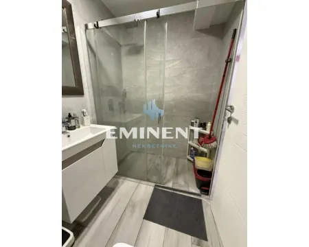 Bathroom with a walk-in shower and a vanity. - image 13