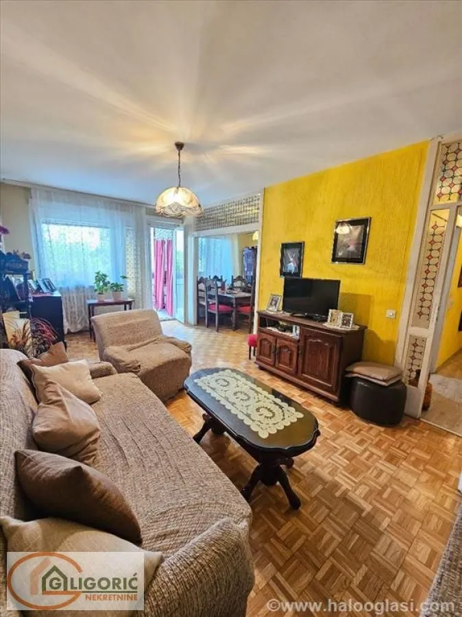 Living room with a sofa, coffee table and TV unit.