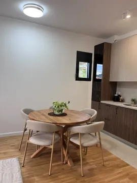 Modern kitchen with a dining table and chairs. - image 5