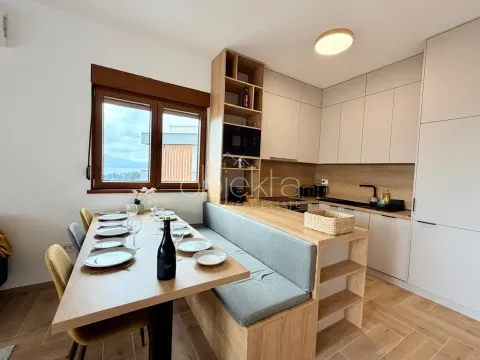 Modern kitchen with a dining area and built-in elements. - image 9