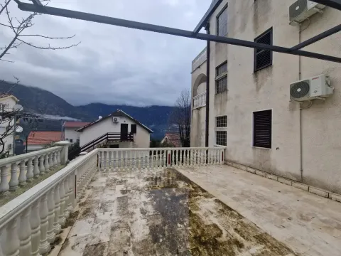 Large terrace with a view of surrounding houses and mountains. - image 5