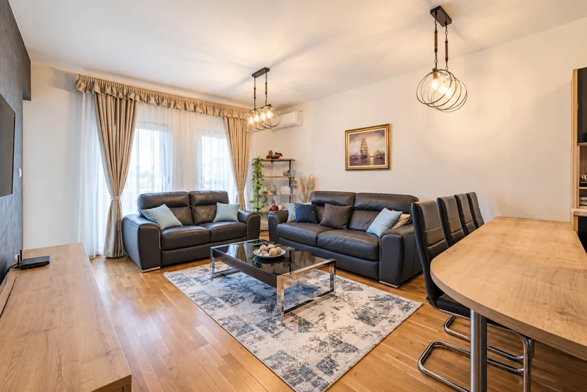 Spacious living room with a sofa set, coffee table, and dining area.