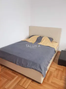 Bedroom with a double bed and parquet flooring. - image 6