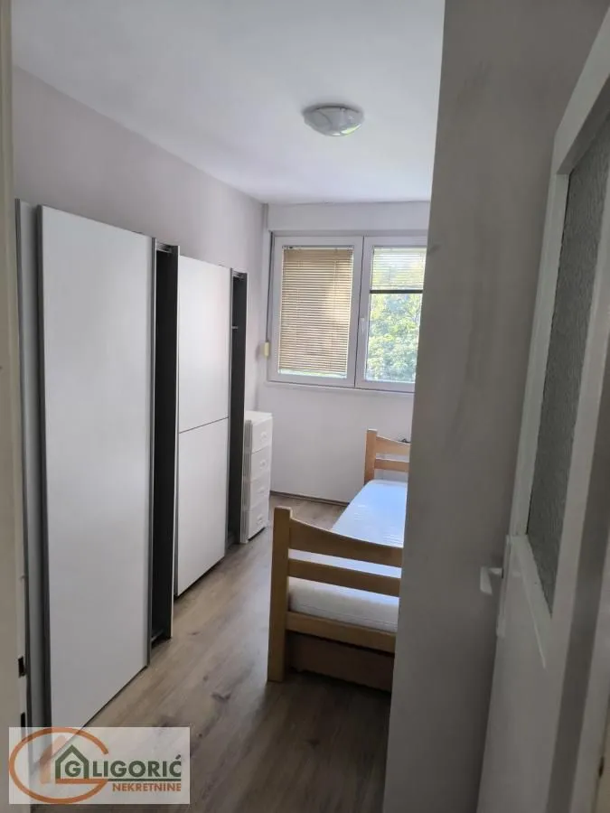 Small bedroom with a bed and fitted wardrobes.