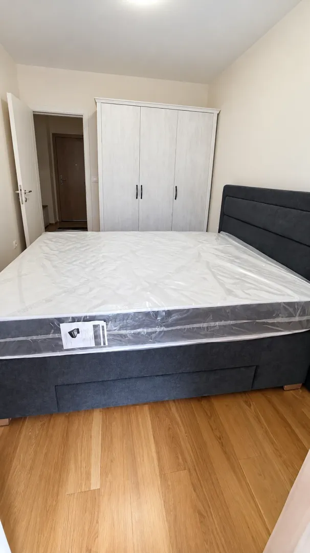 Bedroom with a double bed and white wardrobe.