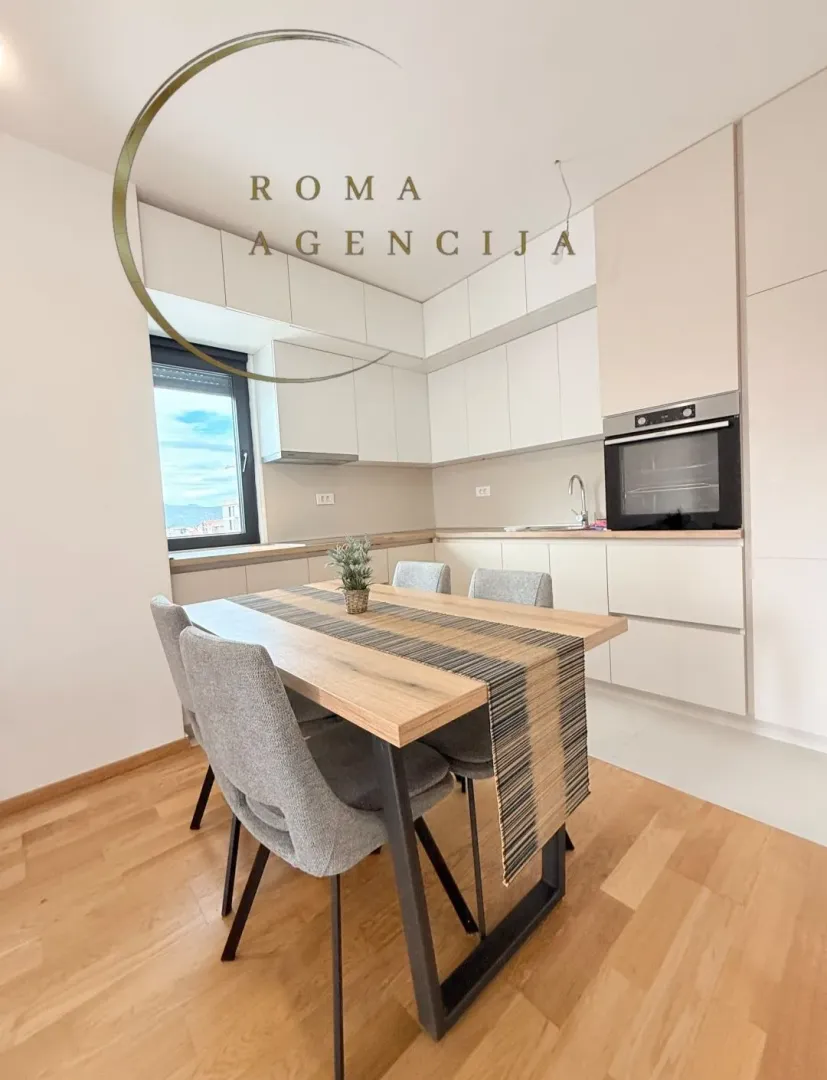 Modern kitchen with a dining table and chairs.