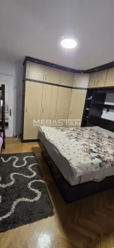Furnished bedroom with a double bed and a large built-in wardrobe. - image 5