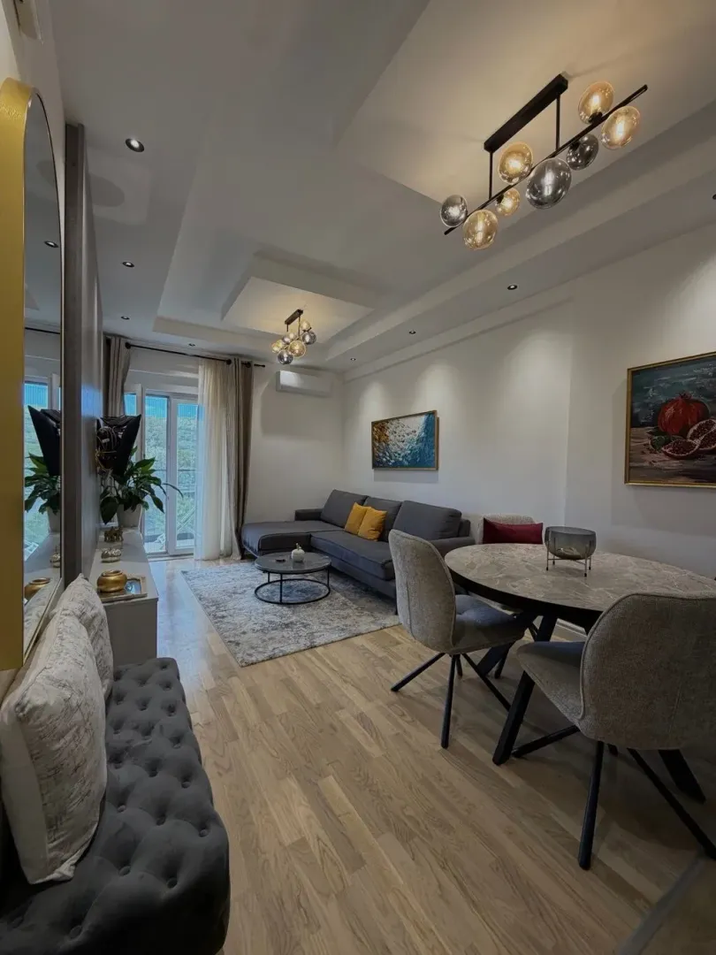 Modern living room with a sofa set and dining area.
