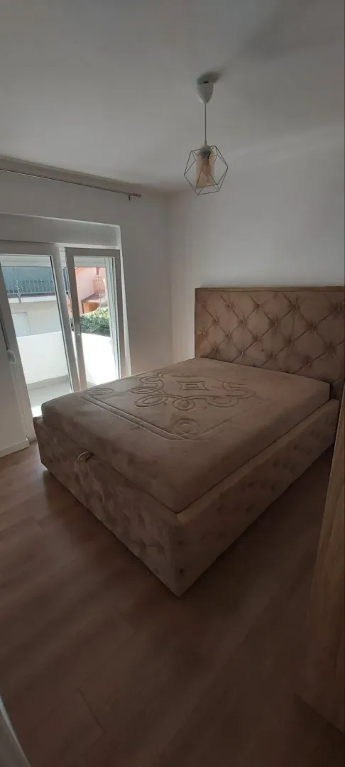 Bright bedroom with a large double bed and balcony access.