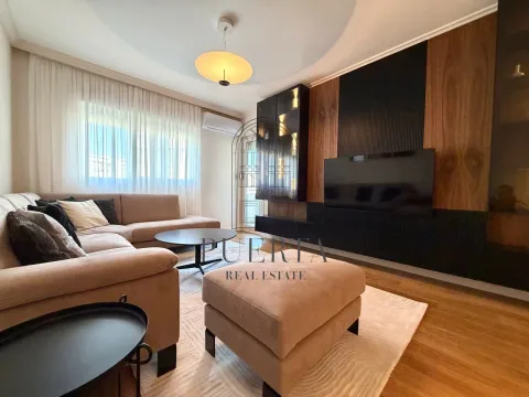 Modern living room with a sofa and TV unit. - image 2