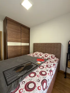 Bedroom with a double bed and a wooden wardrobe. - image 7