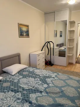 Bright bedroom with a large wardrobe and a bed. - image 5