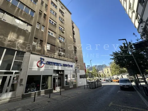 View of the street and the exterior of the building with commercial space on the ground floor. - image 2