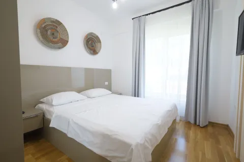 Bright and tidy bedroom with a double bed and decorative wall elements. - image 15