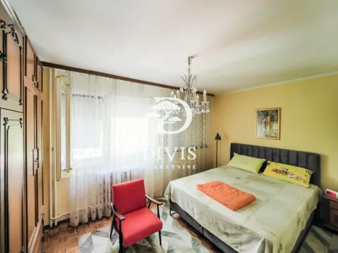 Nameštena spavaća soba sa bračnim krevetom, garderoberom i crvenom foteljom. - image 14